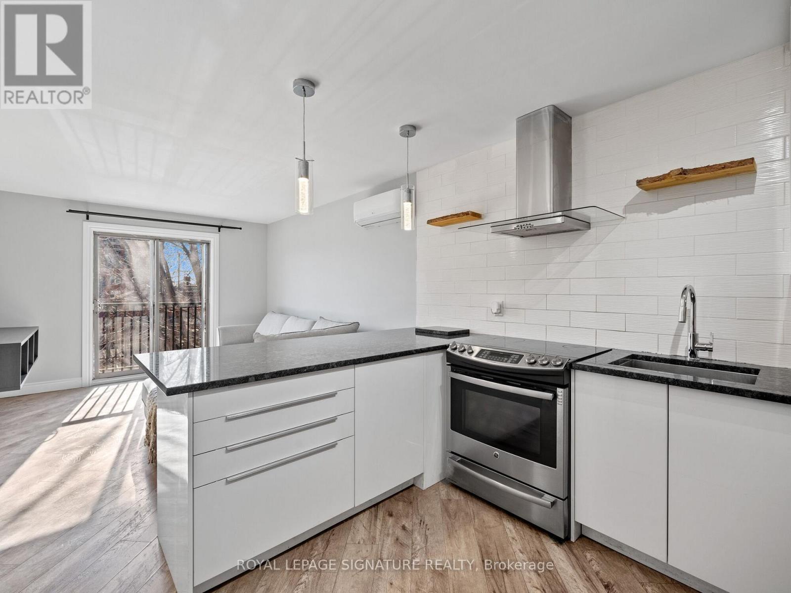 A modern kitchen with white cabinets and a stainless steel oven.