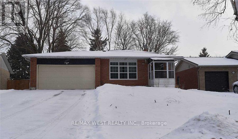 A house with a snow-covered front yard.