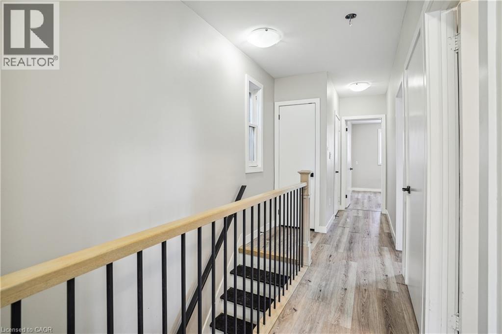 A long hallway with a staircase on the left side.