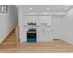 A kitchen with white cabinets and a blue dishwasher.