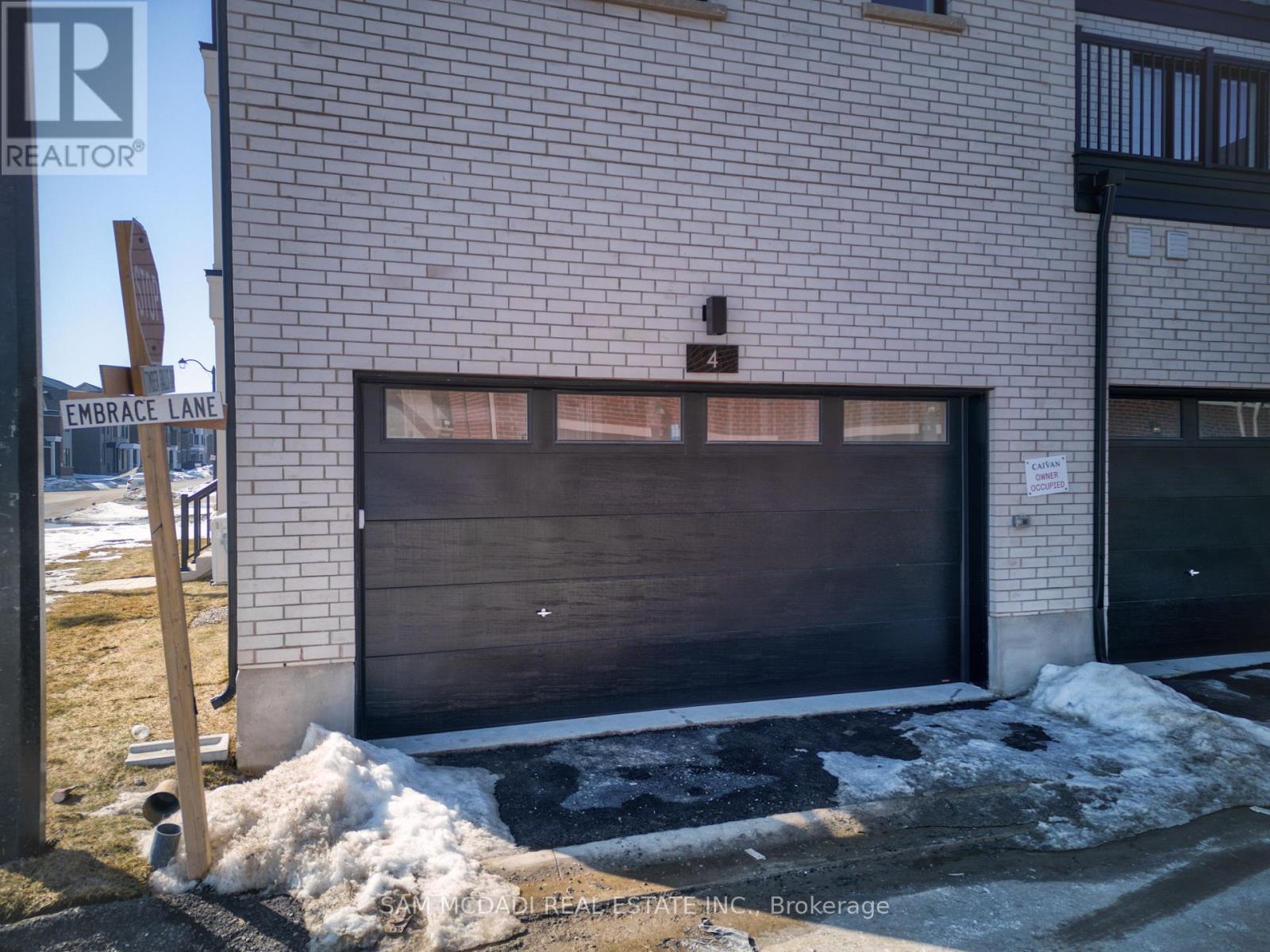 A garage door of a building with a sign that says "REALTOR" on it.