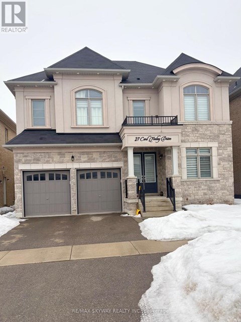 A two-story house with a balcony and a garage.