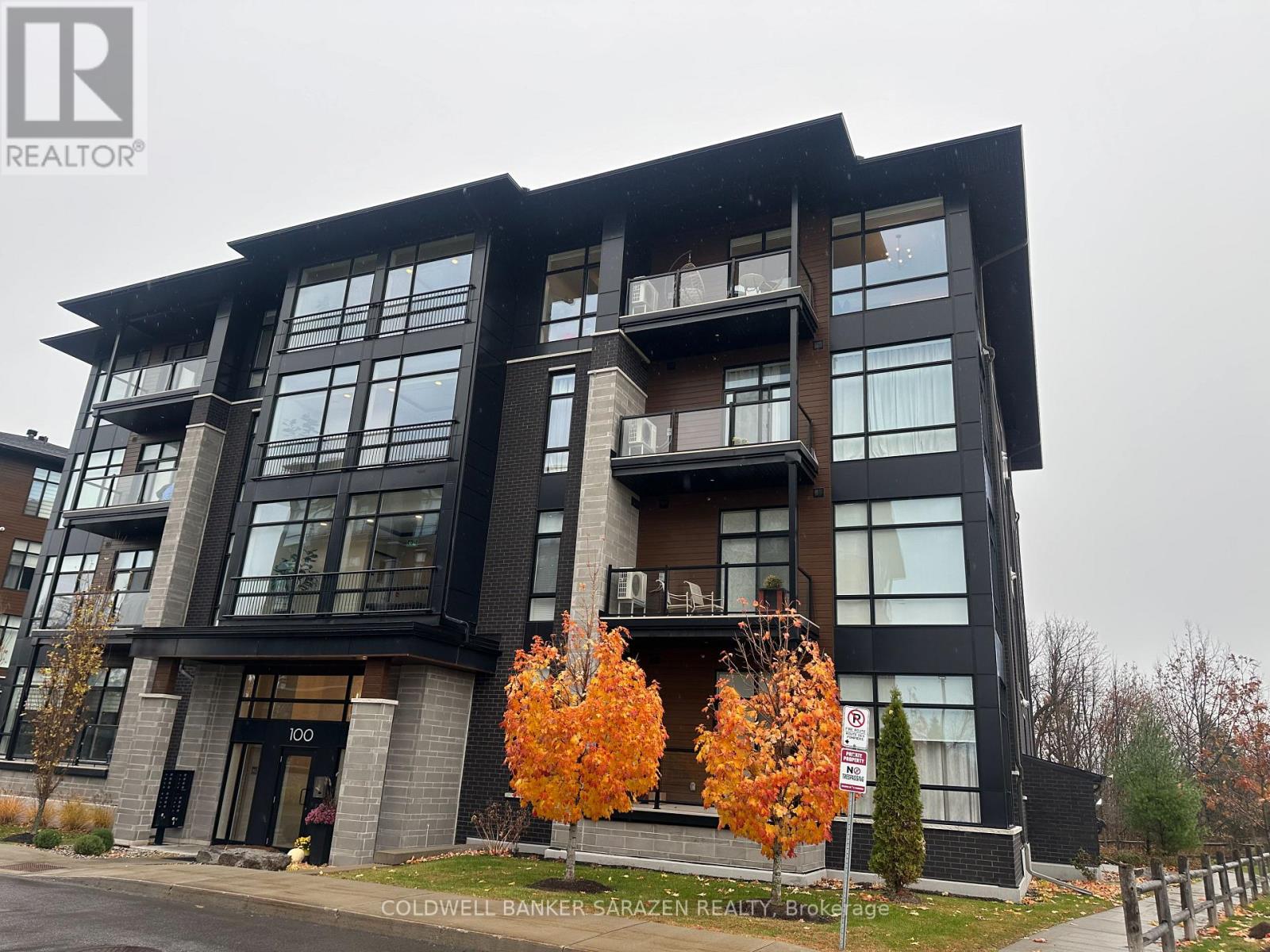 A modern multi-story building with a balcony and a sign that reads "100".
