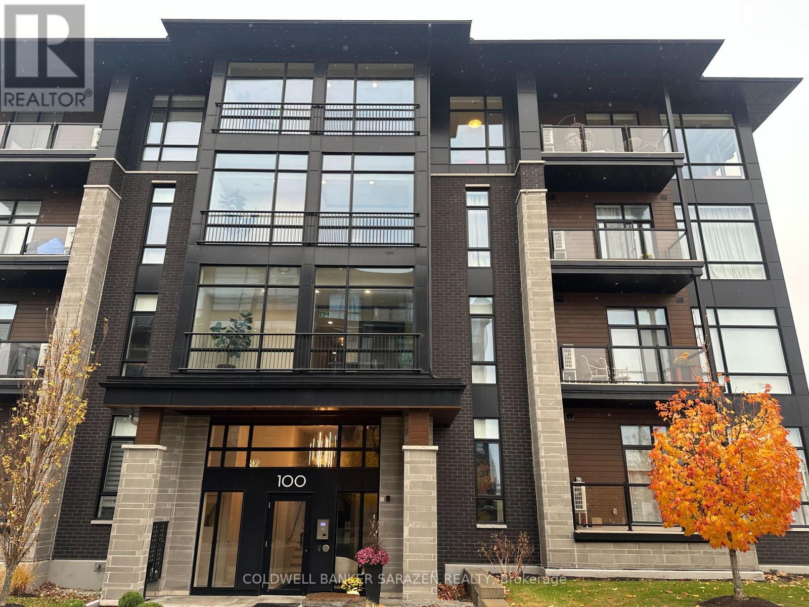 A modern apartment building with the number 100 on the front door.
