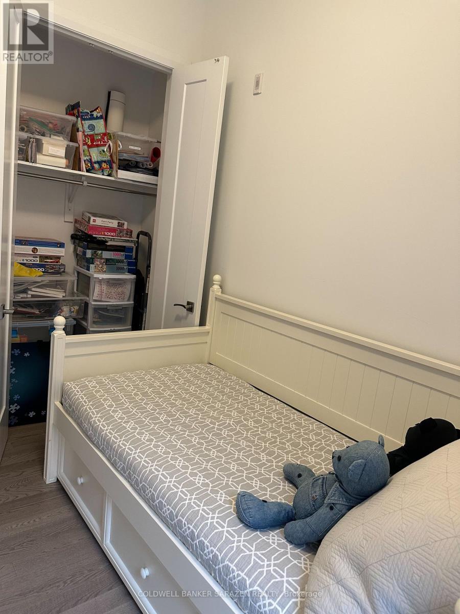 A small child's bedroom with a bed and a small closet.