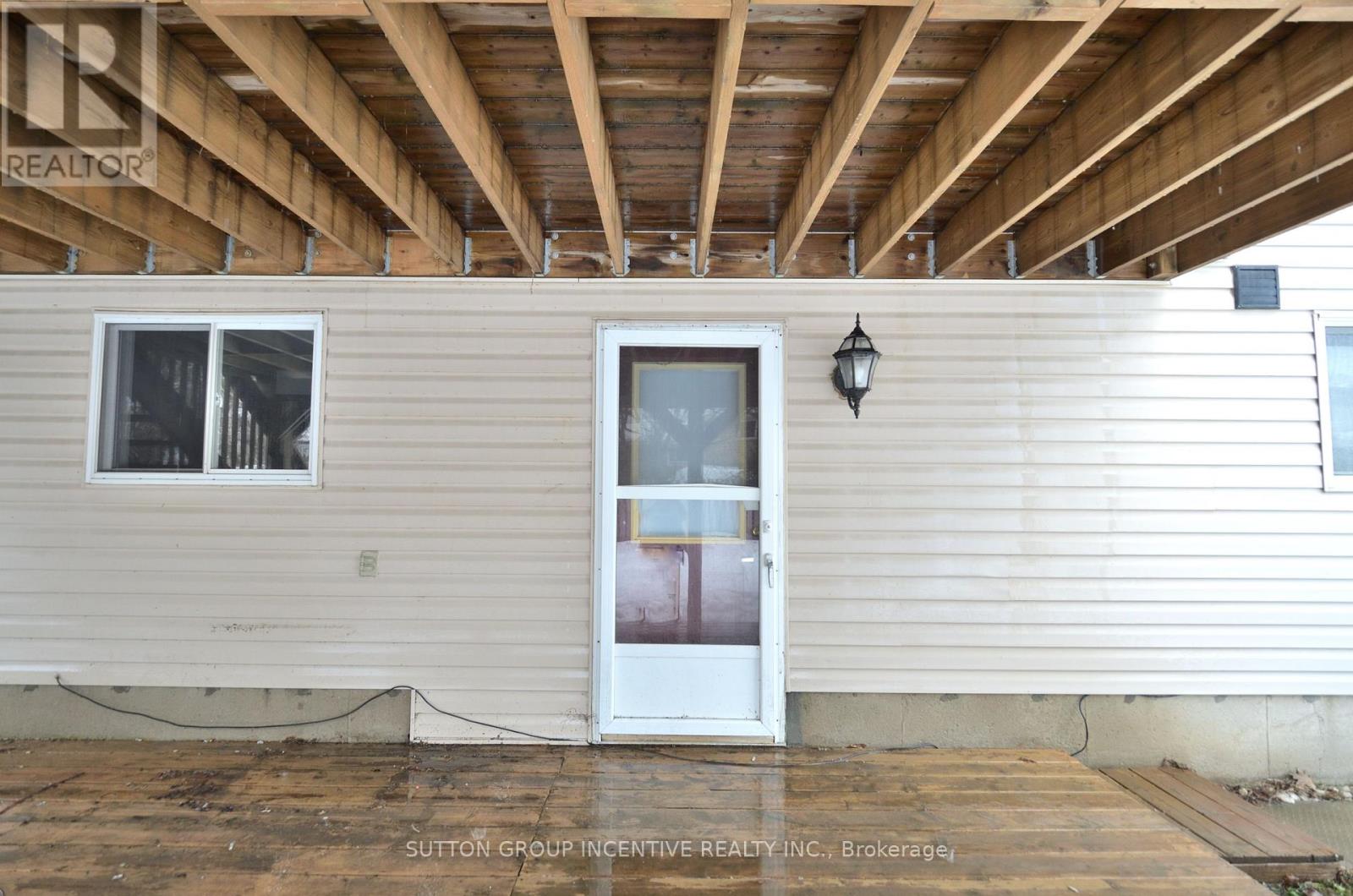 A house with a white door and a window is for sale.