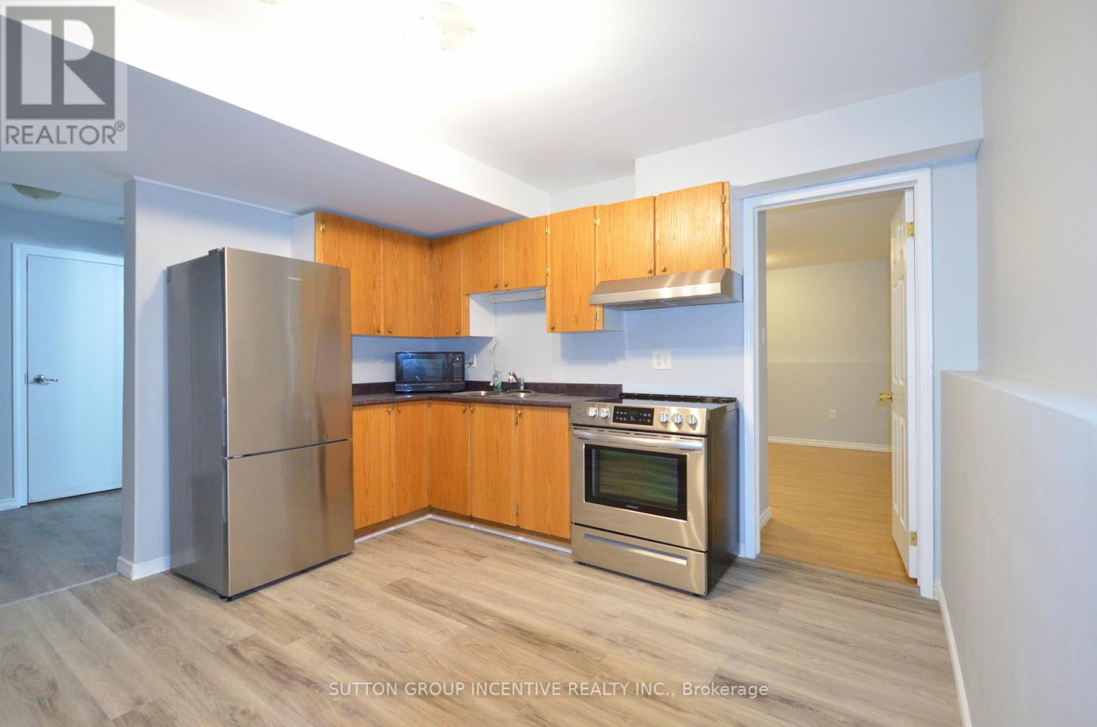 A kitchen with wooden cabinets and stainless steel appliances.