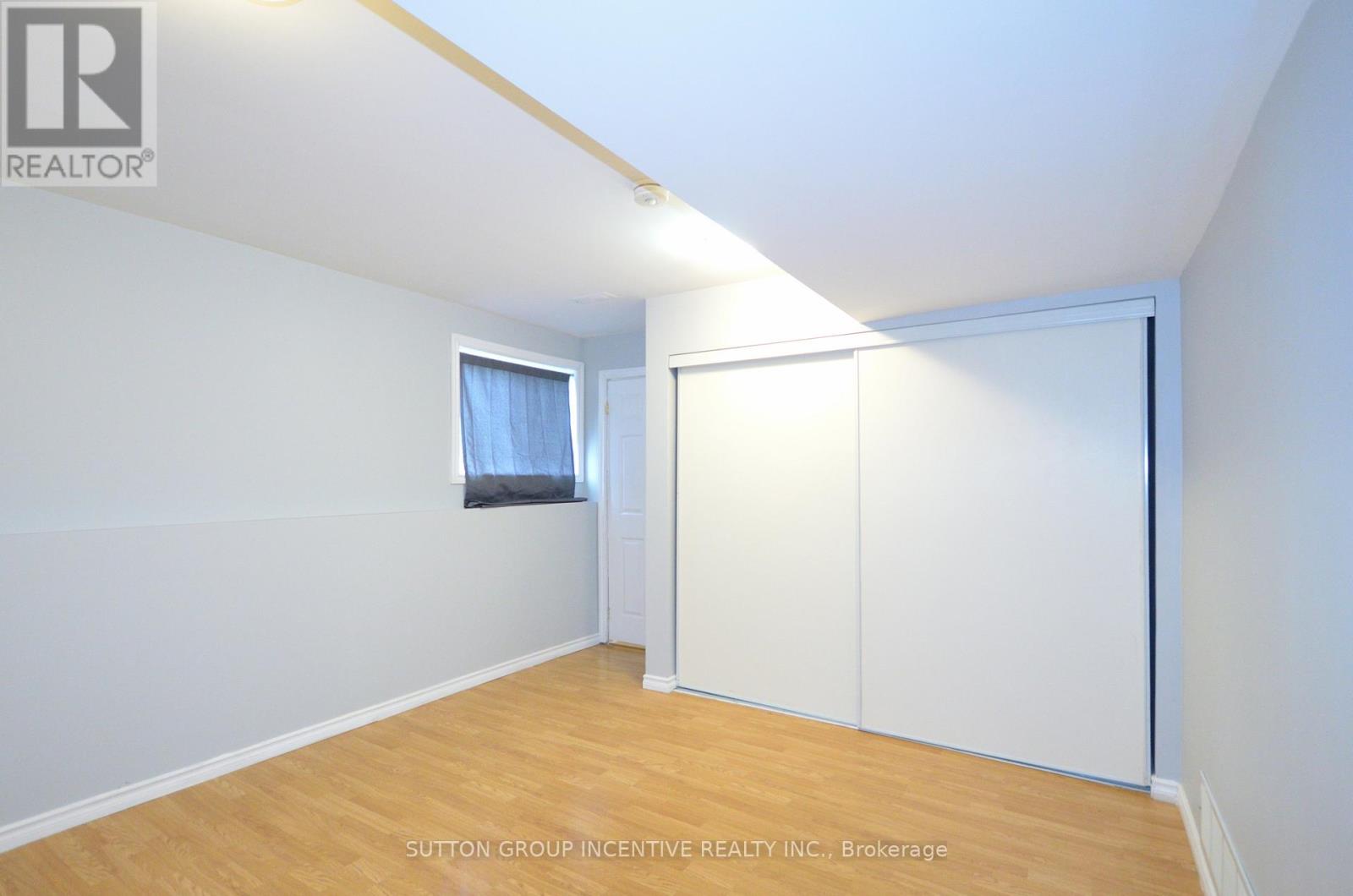 A room with a sliding door and a window with a curtain.