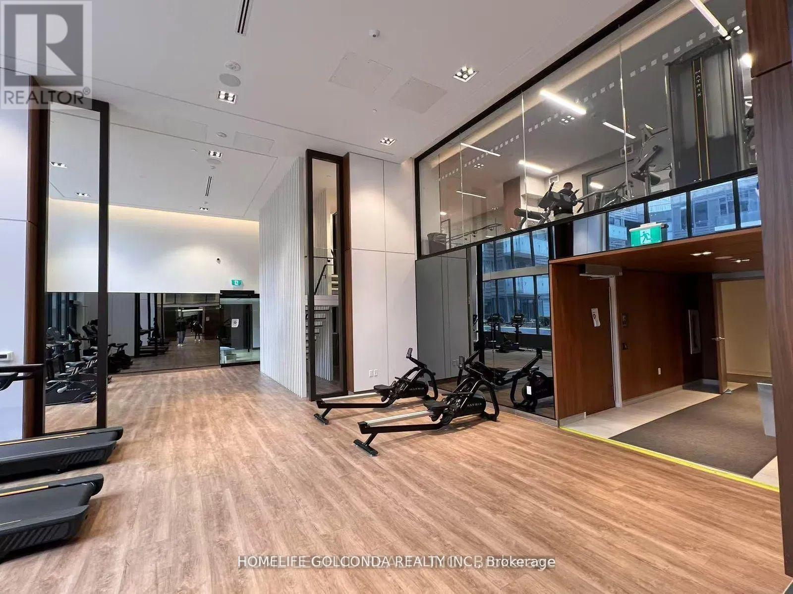 A gym with treadmills, exercise bikes, and mirrors.
