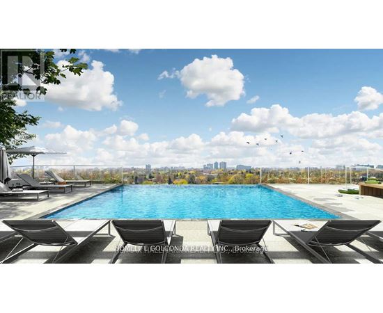 A pool with lounge chairs and a city skyline in the background.