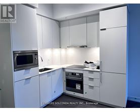A kitchen with white cabinets and appliances is on the market.