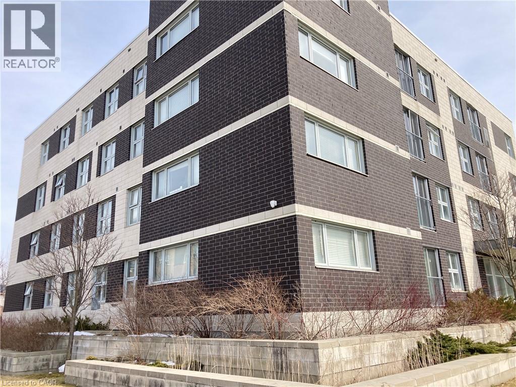 A tall building with a brick facade and multiple windows.