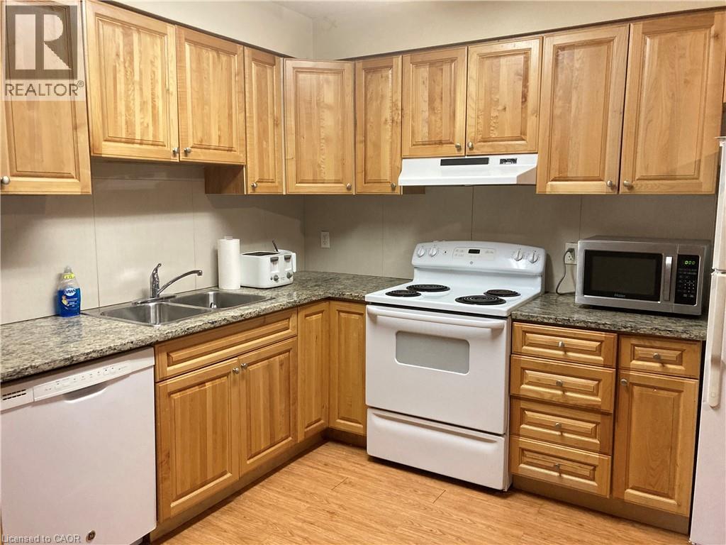 A kitchen with wooden cabinets and white appliances.