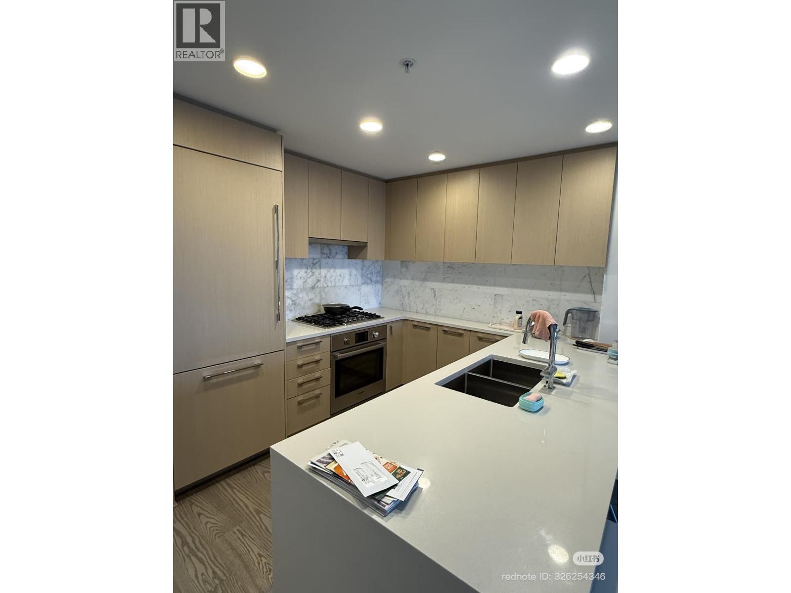 A kitchen with a sink and a counter.