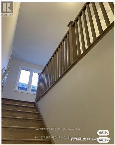 A staircase with wooden steps and a white railing.