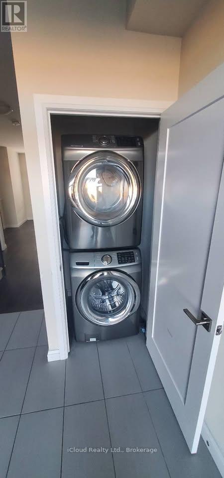 A washing machine is placed in a small cabinet.