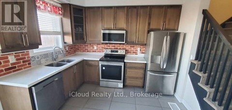 A kitchen with wooden cabinets and a brick backsplash.