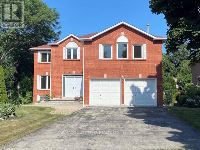A red brick house with a white garage door.