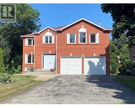 A red brick house with a white garage door.