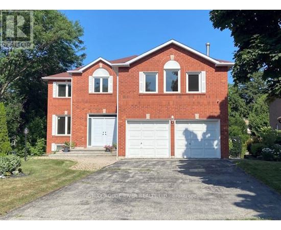A red brick house with a white garage door.