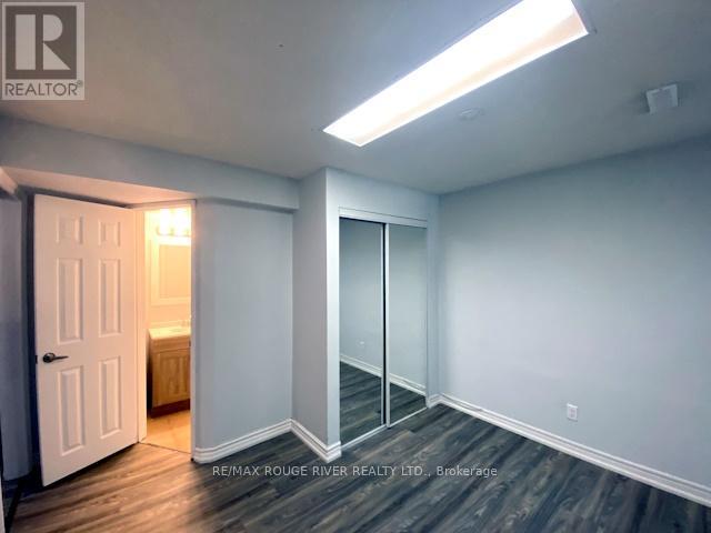 A room with a door and a window with a light on.
