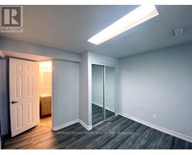 A room with a door and a window with a light on.