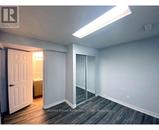 A room with a door and a window with a light on.