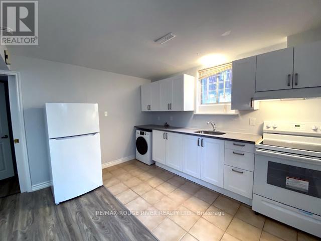 A kitchen with white appliances and cabinets.