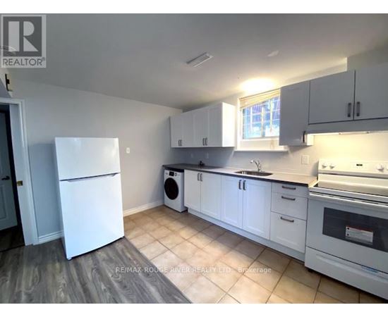 A kitchen with white appliances and cabinets.