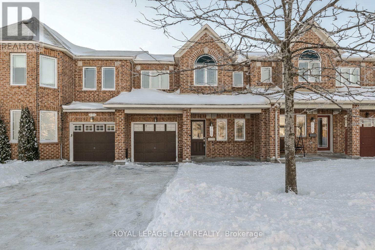 A large brick house with a tree in front of it.