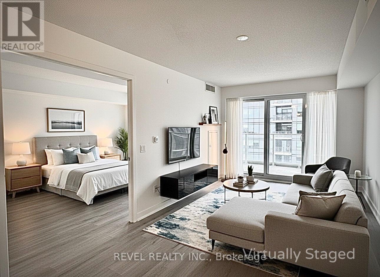 A bedroom with a large bed, a couch, and a television.