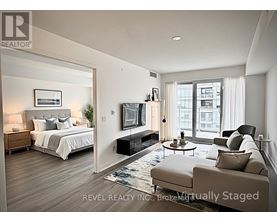 A bedroom with a large bed, a couch, and a television.