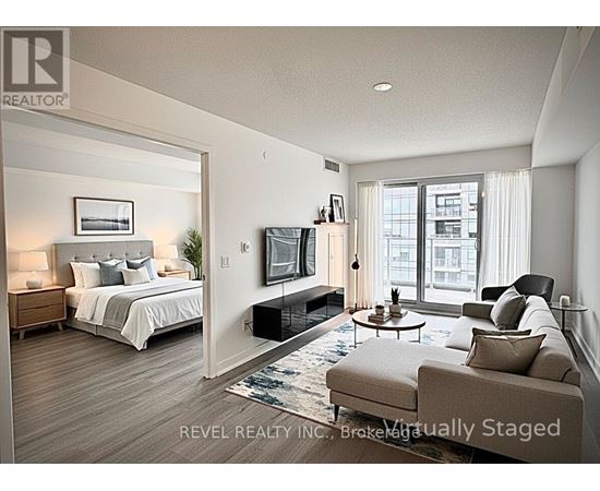A bedroom with a large bed, a couch, and a television.