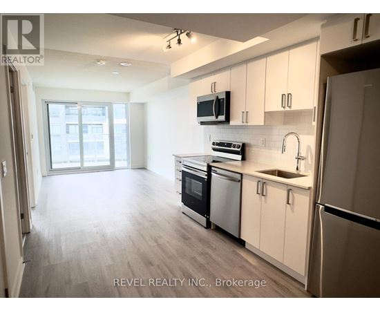A kitchen with white cabinets and stainless steel appliances.