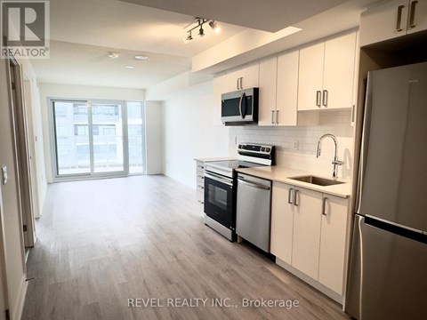 A kitchen with white cabinets and stainless steel appliances.