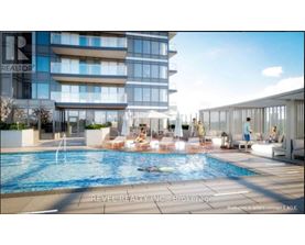 A swimming pool in front of a multi-story building with a sign that says "REALTOR".