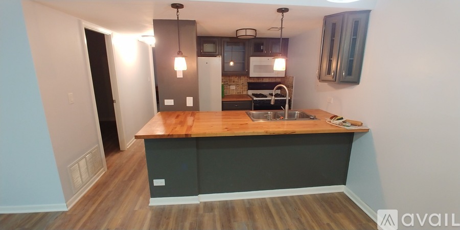 A kitchen with a wooden countertop and a sink.