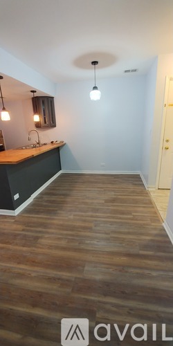 A room with wooden flooring and a white door.