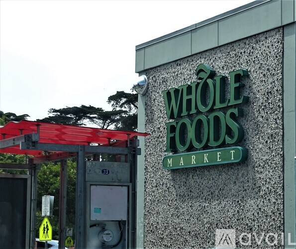 The entrance to a Whole Foods Market with a red awning.