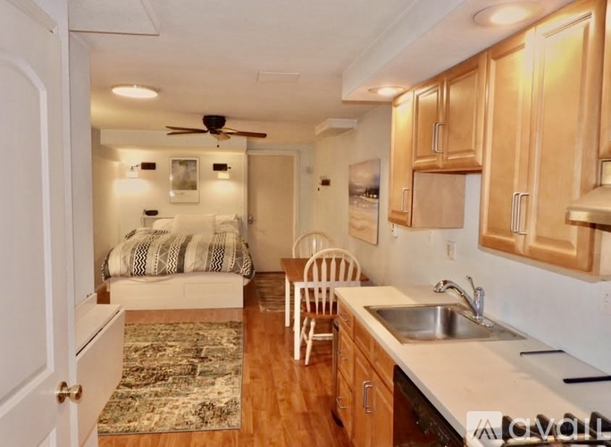 A kitchen with wooden cabinets and a white countertop.
