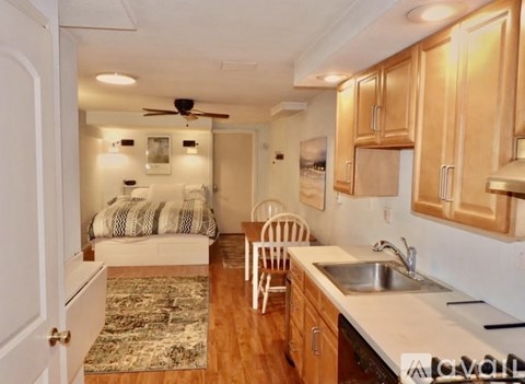 A kitchen with wooden cabinets and a white countertop.