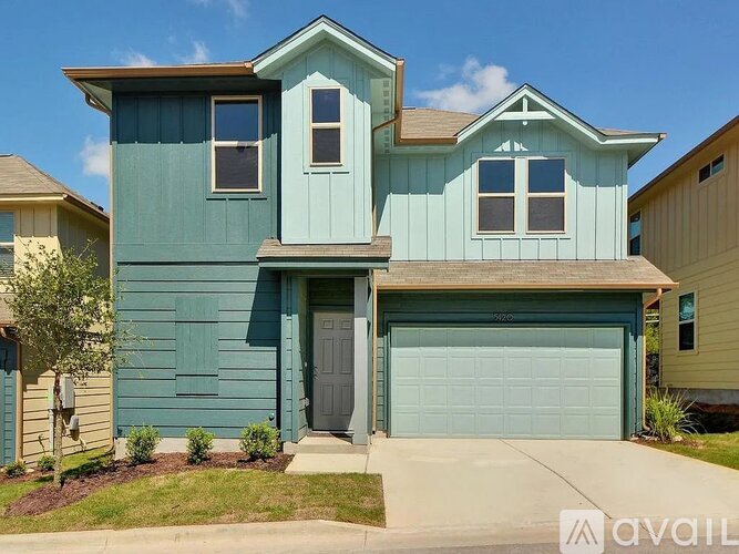 A two-story house with a garage is for sale.