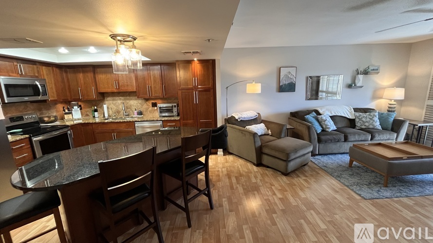 A kitchen with a bar and a couch in the living room.