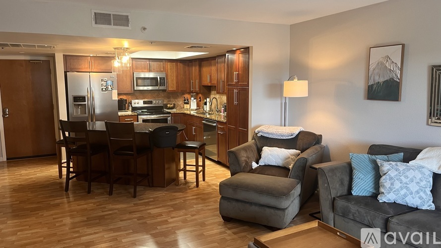 A kitchen with a dining table and chairs is available for rent.