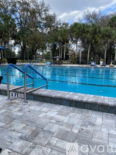 A pool with a blue ladder and a sign that says 6 ft.