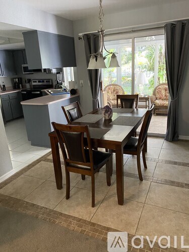 A dining room with a table set for four.