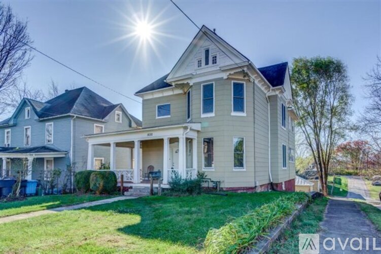 A house with a front yard and a tree.