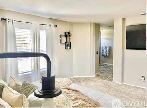 A living room with a couch and a lamp.