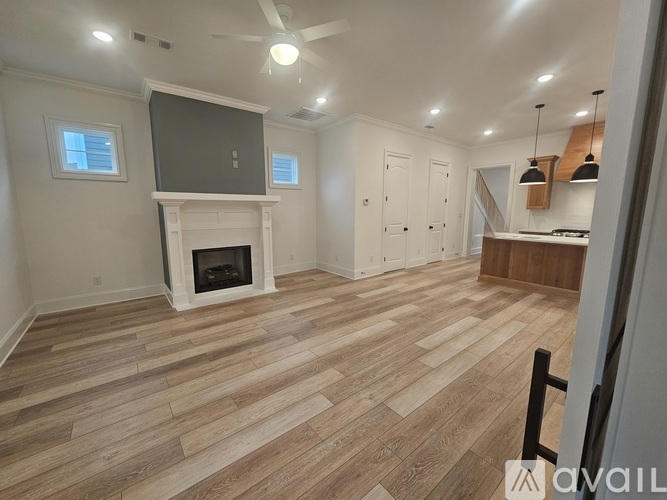 A living room with a fireplace and a television.