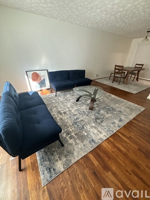 A living room with a blue sofa and a coffee table.